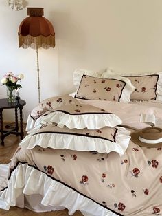 a bed with white sheets and flowers on it