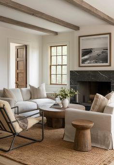 a living room filled with furniture and a fire place in front of a painting on the wall