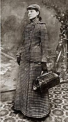 an old black and white photo of a woman in a long coat holding a suitcase