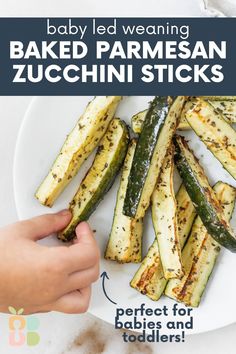 baby led weaning baked parmesan zucchini sticks on a white plate