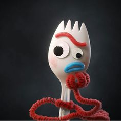 an odd looking fork with a red cord attached to it's head and eyes