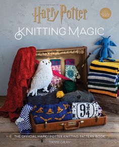 the harry potter knitting magic book is open to reveal an assortment of knitted items