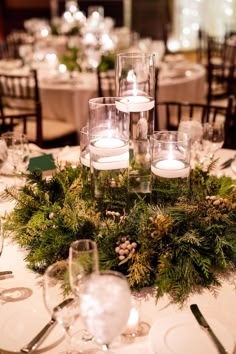 the centerpiece is decorated with candles and greenery