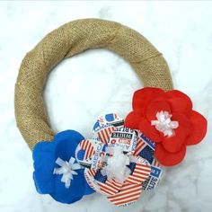 a wreath with red, white and blue flowers on it