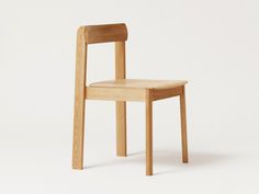 a wooden chair sitting on top of a white floor