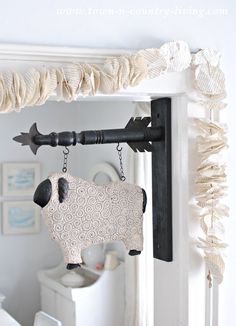 a black and white sheep hanging from a hook