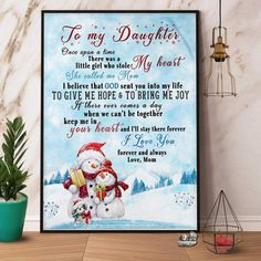 to my daughter poster with snowman and poem on the wall next to potted plant