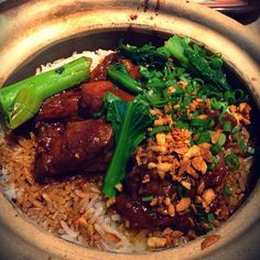 a bowl filled with rice, meat and veggies