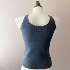 Elegant merino wool tank top. This soft and comfy tank top features a ribbed knit pattern that enhances the fabric's natural stretch and offers a figure-hugging fit. The v-neckline and wide shoulder straps provide a comfortable wear, while also giving it a contemporary edge. Professionally knitted. Features V-neckline, ideal for layering. Yarn Composition:100% Merino Wool Also available in 100% Cashmere option HERE. SIZING:Small/Medium: US size 4-8. Overall length: 21 inches. Measurements might Fitted Ribbed Merino Wool Top, Ribbed Merino Wool Tops For Layering, Fitted Textured Knit Tank Top For Fall, Chic Ribbed Fitted Vest, Stretch Merino Wool Tops In Solid Colors, Stretch Merino Wool Solid Top, Stretch Merino Wool Solid Color Tops, Textured Knit Tank Top, Chic Textured Knit Fitted Tank Top