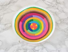 a multicolored bowl sitting on top of a marble counter