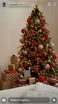 a christmas tree is decorated with red and silver ornaments