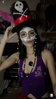 a woman in a skeleton mask and top hat