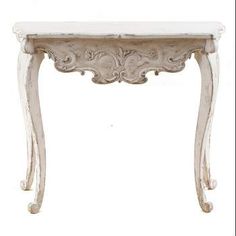 a white table with an ornate design on the top and bottom edge, against a white background