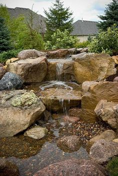 a small waterfall in the middle of some rocks