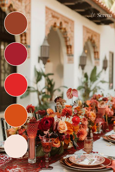 the table is set with red and orange flowers