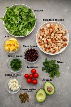 the ingredients to make this salad are neatly arranged in bowls and labeled on each side