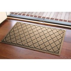 a door mat on the floor in front of a window