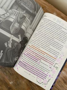 an open book sitting on top of a wooden table