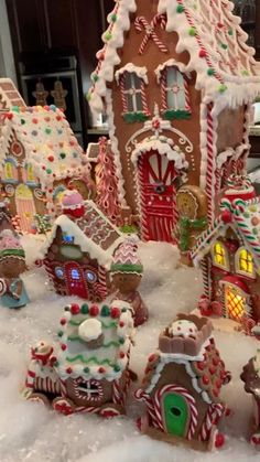 a group of gingerbread houses covered in snow