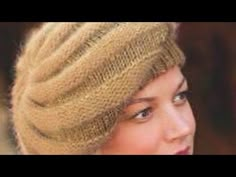 a close up of a person wearing a knitted hat