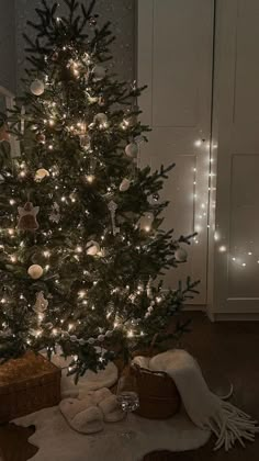 a small christmas tree is lit up with white lights