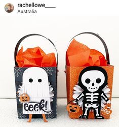 two halloween treat bags decorated with skeleton and pumpkins, one is orange and the other is black