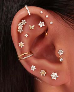 a woman's ear with four different types of piercings