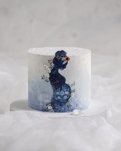 a blue and white cake decorated with an image of a bird on it's head