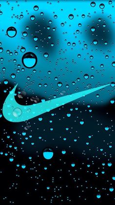 the nike logo is seen through raindrops on a black and blue wallpaper