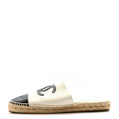 This is an authentic CHANEL Iridescent Goatskin CC Espadrille Mules size 40 in Ivory and Black. These lovely espadrilles are crafted of soft iridescent goatskin leather in ivory with a black leather Chanel CC logo patch and a matching cap toe. Cc Logo, Patch Logo, Espadrilles, Black Leather, Chanel, Leather, Black