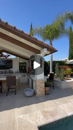 an outdoor kitchen and dining area is shown in this video screen grab from the backyard