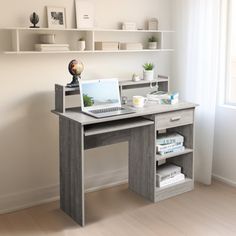 a desk with a laptop on it in front of a window and bookshelves