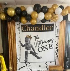 a birthday party with balloons, streamers and decorations on the wall for a baby's first birthday