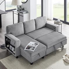 a living room with a gray couch and white rug