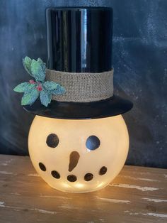 a small light up snowman wearing a top hat