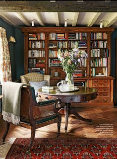 a living room filled with furniture and lots of books