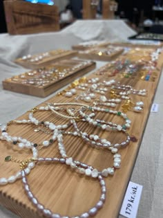 several necklaces are displayed on a table