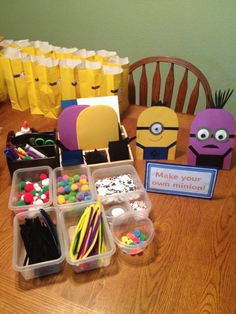 the table is set up with plastic containers filled with candies and other items to make an angry minion