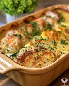 a casserole dish with cheese and vegetables in it on a table next to broccoli