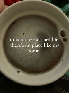 someone holding a coffee cup with the words romanticize a quiet life, there's no place like my room