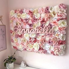 a pink and white flowered wall with the word anabella on it