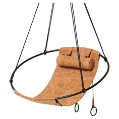 a brown leather swing chair hanging from the ceiling