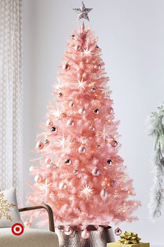 a pink christmas tree in a living room