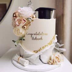 a graduation cake decorated with flowers and decorations