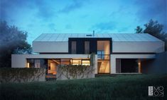 a modern house is lit up at night in front of the trees and grass area