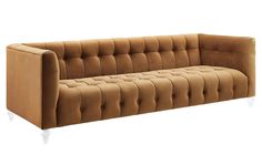 an image of a couch that is in the shape of a tufted upholstered sofa