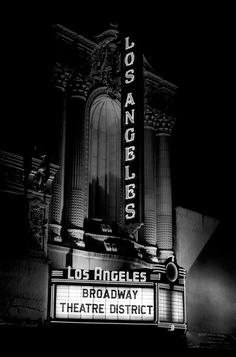 the los angeles broadway theatre sign lit up at night