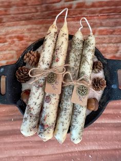 some kind of food that is in a pan with pine cones and cinnamons on it