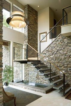 a stone and steel staircase in a modern home