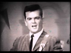 an old black and white photo of a man singing